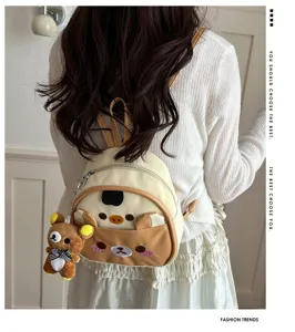 Cute cartoon bear PU leather mini backpack with plush pendant, stylish casual daypack for women.