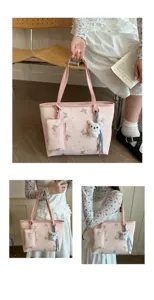Dettaglio in primo piano della borsa tote rosa con stampa farfalla e ciondolo coniglio.