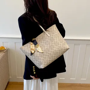 Large capacity women shoulder tote bag detail shot showing elegant monogram pattern and scarf.