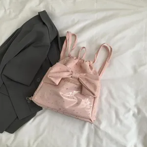 Zaino rosa con stampa di stelle, coulisse e grande fiocco decorativo elegante.