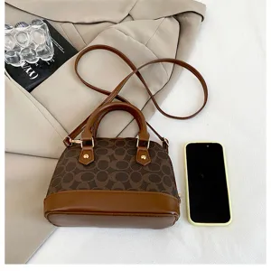Detailed view of the vintage brown monogram dome handbag with top handles and shoulder strap.