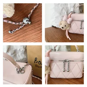 Chic pink quilted crossbody bag with top handle, cute puppy pendant, and elegant chain strap.