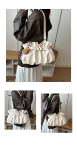 Off-white gathered shoulder bag with metal buckle detail and cute plush bear charm accessory.