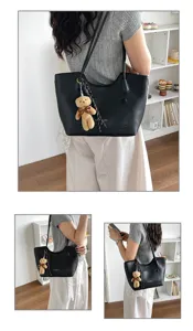 Stylish black PU leather tote bag with cute bear pendant, large capacity commuter handbag.