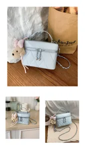 Chic light blue quilted vanity crossbody bag with cute puppy plush charm for women daily commute.