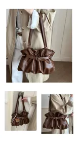 Detail view of brown pleated shoulder bag showing styling and strap design for daily commute.