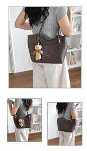Stylish brown leather tote bag for women, large capacity commuter shoulder bag with charm.