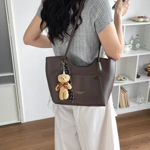 Retro brown commuter tote bag for women, large capacity shoulder bag with bear pendant.
