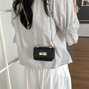 Trendy black glitter mini crossbody bag with chic chain strap and gold tone lock closure