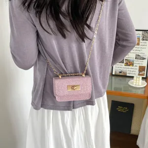Pink tweed crossbody mini bag with gold chain strap, stylish summer square shoulder bag for women.