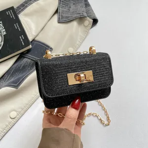 Mini black tweed crossbody bag with gold chain strap and elegant turn-lock closure for women.