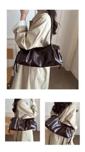 Detailed view of the dark brown pleated shoulder bag, showing texture and model wearing style.