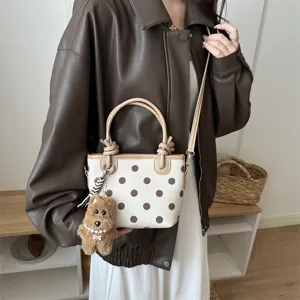 Retro minimalist polka dot canvas bucket bag with shoulder strap and cute puppy pendant for women.