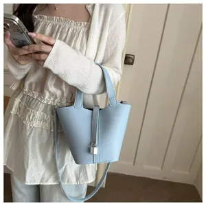 Light blue leather bucket bag with padlock design stylish casual handbag for women daily use.