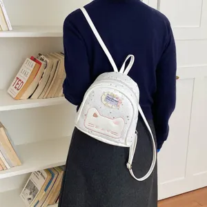 Cute white small backpack for women, cartoon cat face design, stylish student casual daypack.