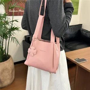 Pink lychee pattern bucket bag detail view, stylish women shoulder crossbody bag for daily commute.