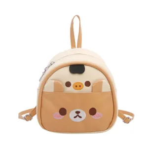 Cute cartoon PU leather mini backpack for women and kids, stylish beige and brown casual daily bag.