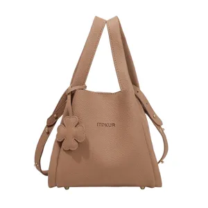 Women's textured leather bucket handbag, stylish top-handle crossbody bag for daily commute.