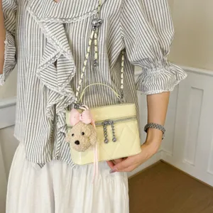 Chic quilted vanity shoulder bag with chain strap and cute plush dog charm for women.