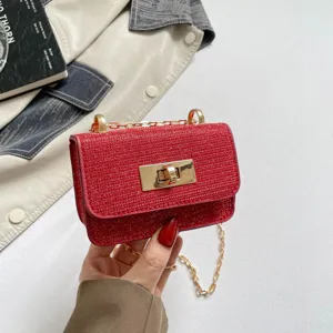 Red sequin mini crossbody bag detail, featuring gold-tone hardware and chic turn-lock closure.