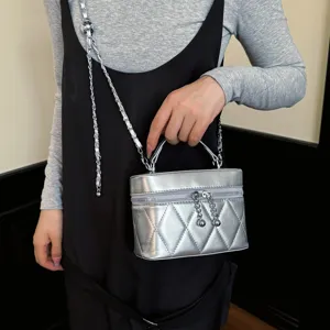 Silver quilted vanity shoulder bag, detail view showing metallic chain strap and metal zipper.