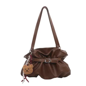 Brown faux leather slouchy shoulder bag for women with cute bear charm and ruched style.