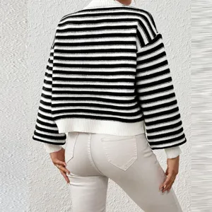 Detailed view of the stylish black and white striped knitted sweater with lantern sleeves.