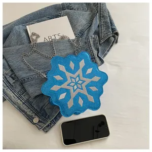 Detail view of unique blue glitter snowflake cross-body bag with stylish silver chain strap.