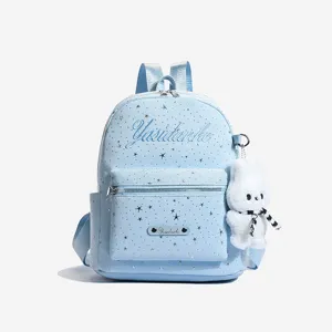 Light blue leather backpack for women with cute star patterns and fluffy bunny pendant.