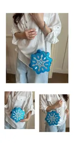 Detailed view of the sparkling blue snowflake crossbody bag worn, highlighting the design.