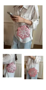 Detailed view of the pink glitter snowflake crossbody bag with metal chain strap worn.