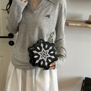 Stylish black snowflake shaped chain crossbody bag with unique winter design and metallic strap.