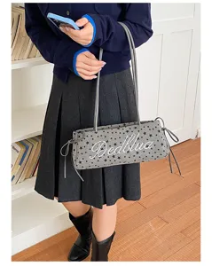 Vista dettagliata di una borsa a spalla con stampa di stelle e design casual chic da spalla.