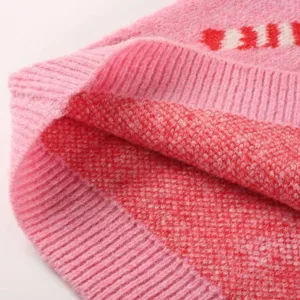 Roze gebreide truistof detail close-up, zachte winterkleding textuur weergave