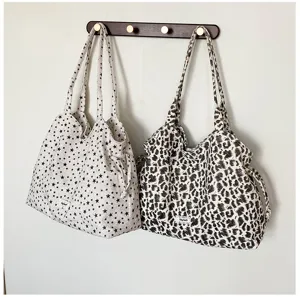 Detailed shot of Korean style canvas tote shoulder bags with star and leopard prints hanging.