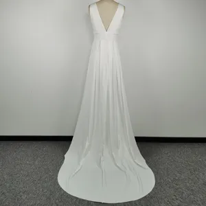 Back view detail of elegant white sleeveless deep v-neck trailing wedding gown dress.