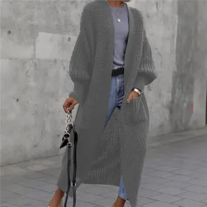 Nahaufnahme der kuscheligen Strickstruktur und der BallonsÄrmel des langen grauen Cardigans.