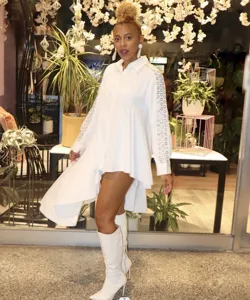 White long sleeve oversized button-down shirt with stylish sleeve grommet cutout details.