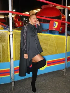Fashionable black asymmetrical long sleeve shirt dress with metal eyelet cutouts for women