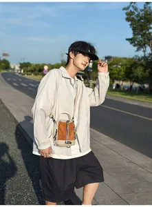 Outdoor lightweight casual crossbody shoulder bag detail, stylish two-tone design for travel.