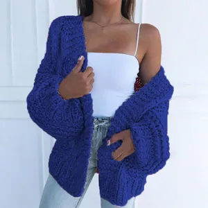 Close-up of chunky knit cardigan texture, soft material, cozy winter style detail.