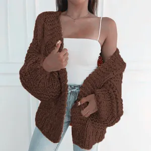 Chunky knit cardigan detail shot showing soft brown texture, long sleeves and open front style.