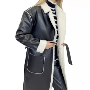 Close-up detail of the black faux leather shearling coat showing the soft plush lapel and belt.