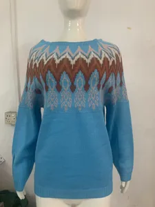 Close-up detail view of light blue knit sweater featuring colorful zig-zag pattern yoke design.