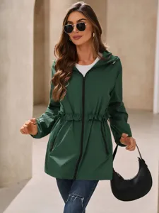 Close-up detail of the dark green hooded windbreaker jacket with zipper and drawstrings.