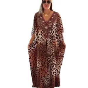 Leopard print beach cover-up detail, V-neck embroidery, loose caftan fit for holiday.