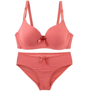 Coral pink seamless bra set detail, smooth molded cups with cute bow accent for women.