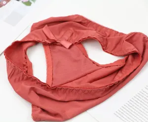 Detailed view of red seamless women panties featuring delicate lace trim and cute bow accent.