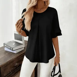 Detail view of a casual black blouse with tiered ruffle sleeves, round neck, and pleated front.