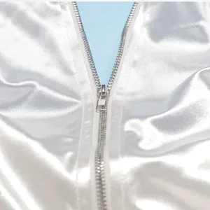 Close-up detail of smooth satin dress zipper, showing premium fabric texture and metal hardware.